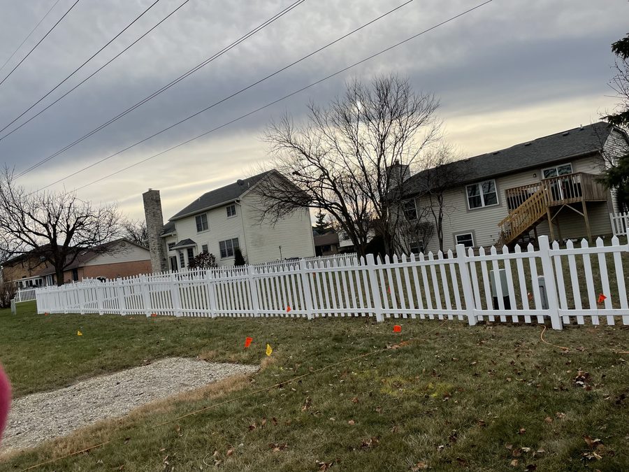 White vinyl picket fence installed by Broadway Fence LLC