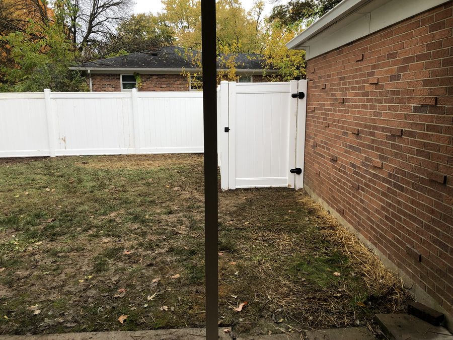 White vinyl privacy fence with gate installed by Broadway Fence LLC
