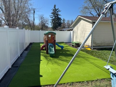 White vinyl privacy fence around playground installed by Broadway Fence LLC