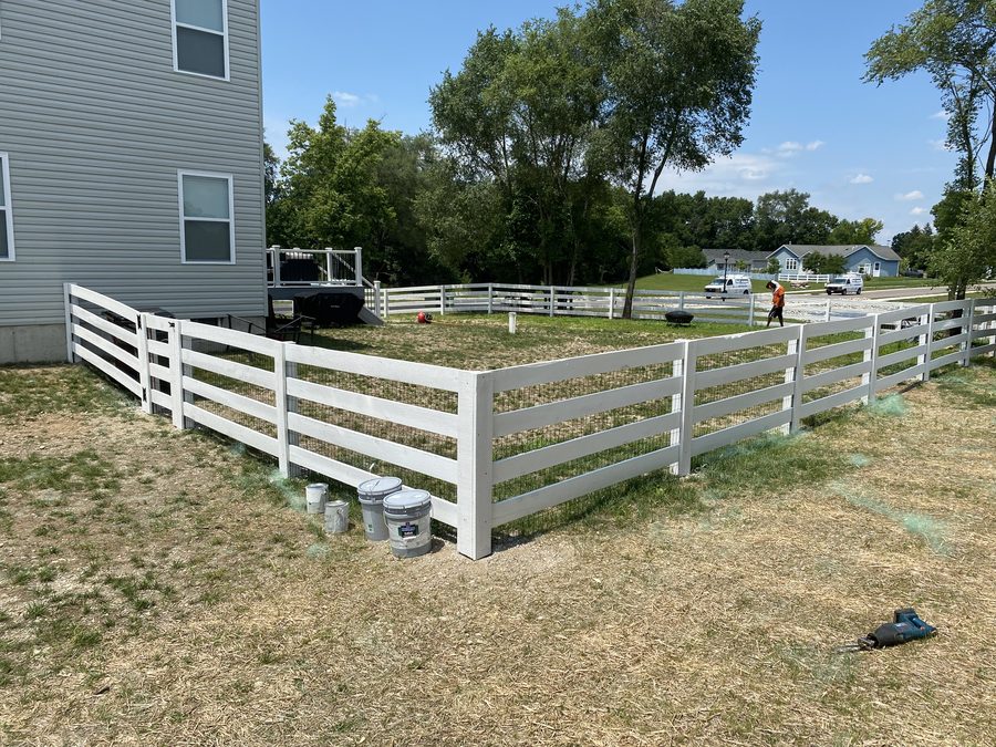 White painted wood 4-rail ranch paddock fence by Broadway Fence LLC