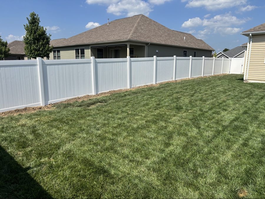 White vinyl privacy fence installation in Dayton Ohio residential yard