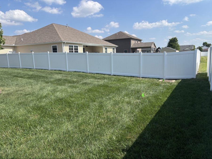 White vinyl privacy fence enclosing a large Dayton backyard