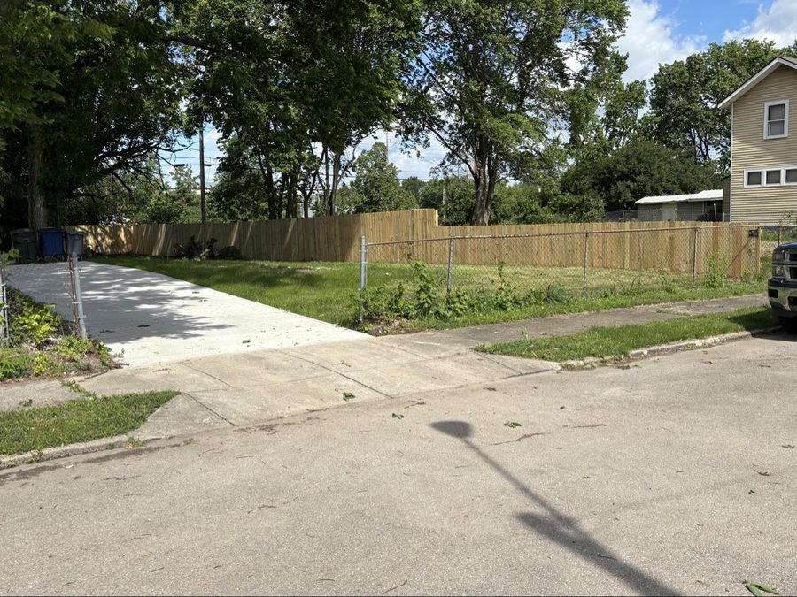 Wood privacy fence installation along Dayton residential street