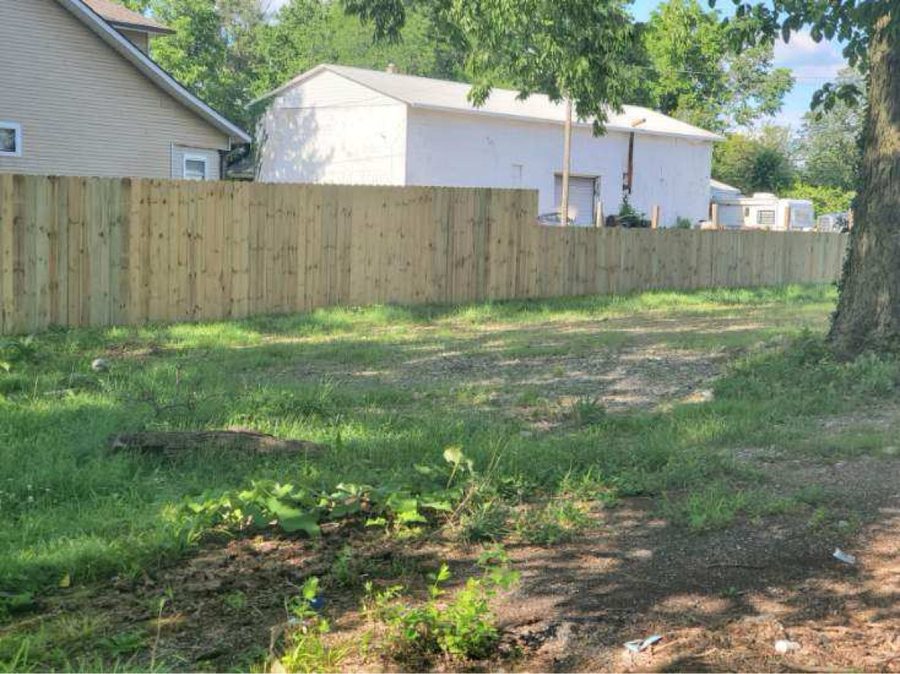 Pressure-treated wood privacy fence in large Dayton yard